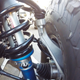 The coilover shock looks big as a sewer pipe. You can also see the Raptor’s robust control arms, axles and tie rod ends from here (Photo Credit: Andrew Collins)